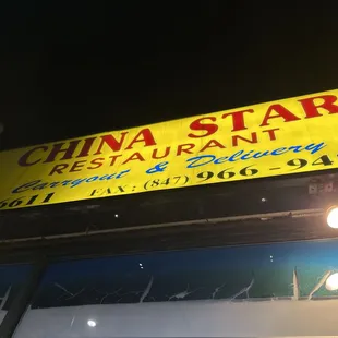 a yellow sign above a restaurant