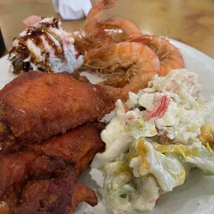 Fried chicken wings, seafood salad, crispy fried shrimp and sushi.