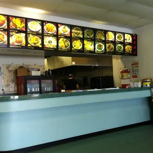the counter and menus of a chinese restaurant
