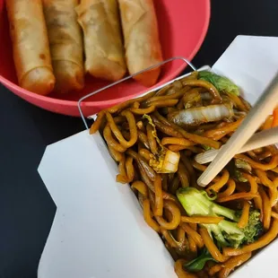 a plate of noodles and a bowl of vegetables