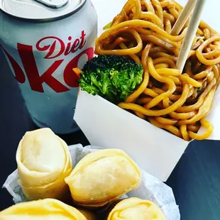 a bowl of noodles, broccoli and a can of diet k