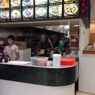 a restaurant counter with menus in the background