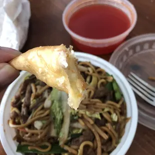 a hand holding a piece of food