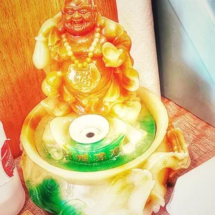 a statue of a smiling buddha