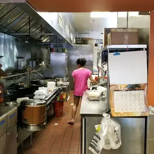 a woman in a kitchen preparing food