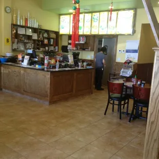 a restaurant with a counter and chairs
