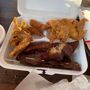 a tray of fried food and fries