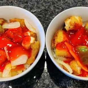 A portion of sweet and sour chicken re-plated to two bowls. Thin and crispy coated, well-cooked, moist chicken with perfect sauce and rice.