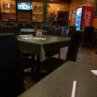 a dining area with tables and chairs
