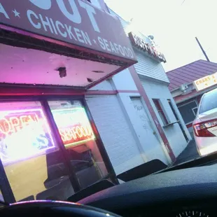 a car driving past a restaurant