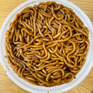 a bowl of chinese noodles on a table