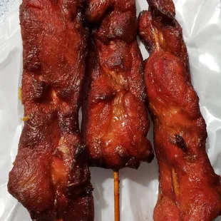 three skewered meats on skewers