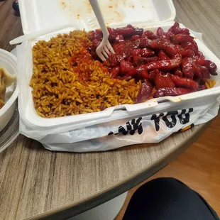 a tray of rice and beans with a fork in it