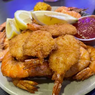 a plate of fried shrimp and other food items