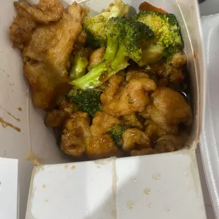 chicken and broccoli in a takeout box