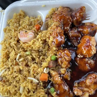 a takeout container with rice, meat and vegetables