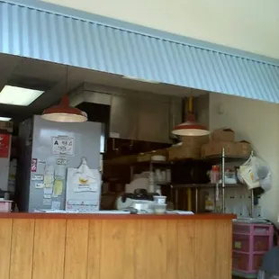 a kitchen with a counter and a refrigerator