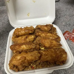 Chicken wings with pork fried rice. The wings are pretty big not too bad but the rice is cooked in way too much soy sauce.