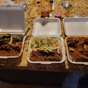 three takeout containers of food on a counter