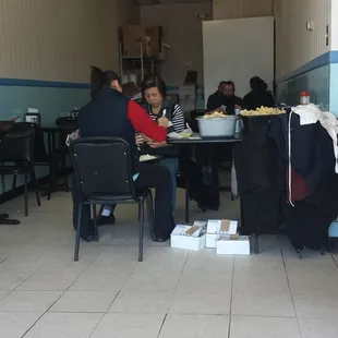 Small dining area. Ladies preparing crab Rangoon.