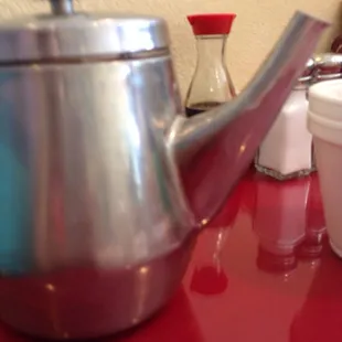 a tea pot and cups on a table