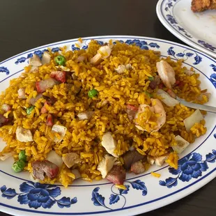 a plate of rice with meat and vegetables