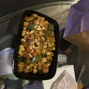 Kung Pao Chicken with various course chopped questionable veggies and raw peanuts.