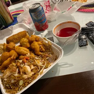 a tray of fried food and a can of soda