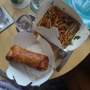 One of two egg rolls, rice and pork lo mein