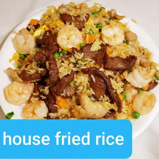 a plate of fried rice with beef and shrimp