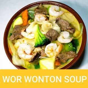 a bowl of soup with shrimp and vegetables