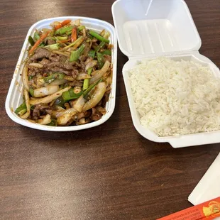 two takeout containers with rice and beef