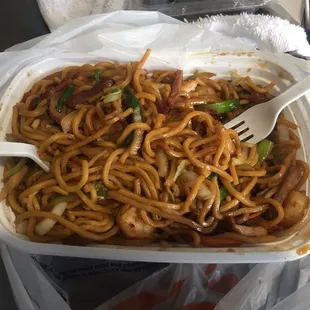 noodles in a plastic container with a fork