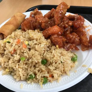 a plate of rice, meat and vegetables