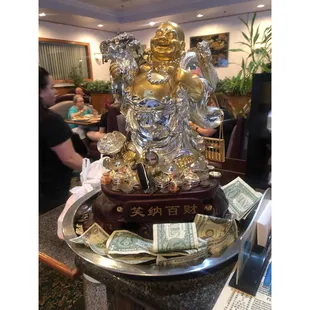 Rub his belly for good luck.