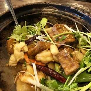 a bowl of food with meat and vegetables