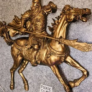 a statue of a man riding a horse