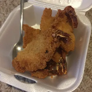 a fork in a container of fried food