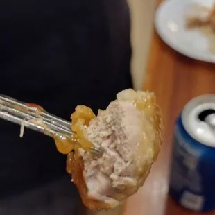 a person holding a fork full of food