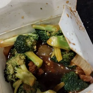 broccoli and mushrooms in a takeout box