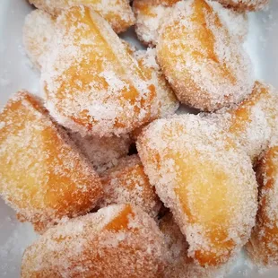 a pile of sugared doughnuts