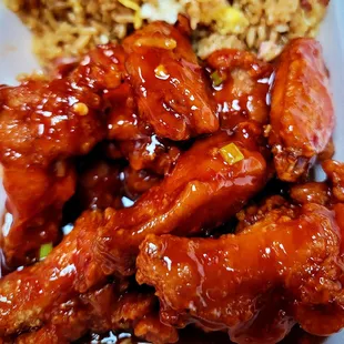 a plate of chicken wings and rice