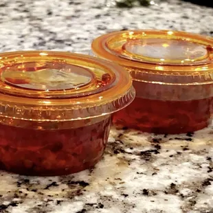 two jars of jam on a counter