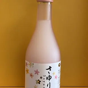 a pink bottle with writing on it