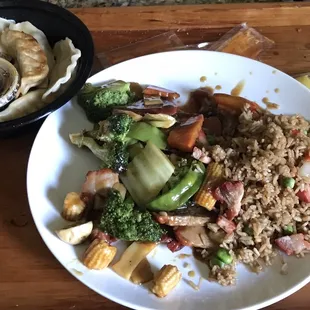 Pan fried pork dumplings, roast pork with vegetables and pork fried rice.