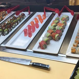 a variety of sushi rolls on display