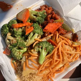 broccoli and noodles in a take out box