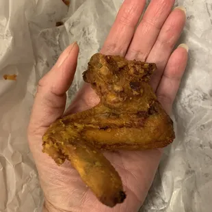 1 of 4 chicken wings, $9, omgosh , I have small hands I swear!!! BTW that&apos;s the greasy bag there.