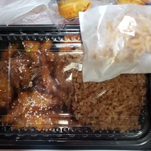 a plastic container filled with rice and meat