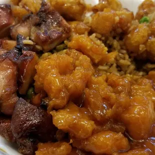 a white styrofoam container filled with meat and rice